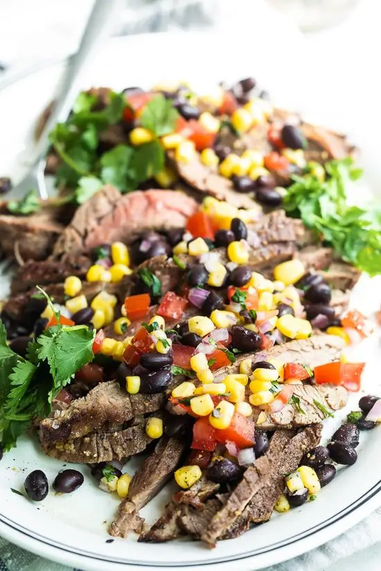 steak with tomatoes, corn and black beans