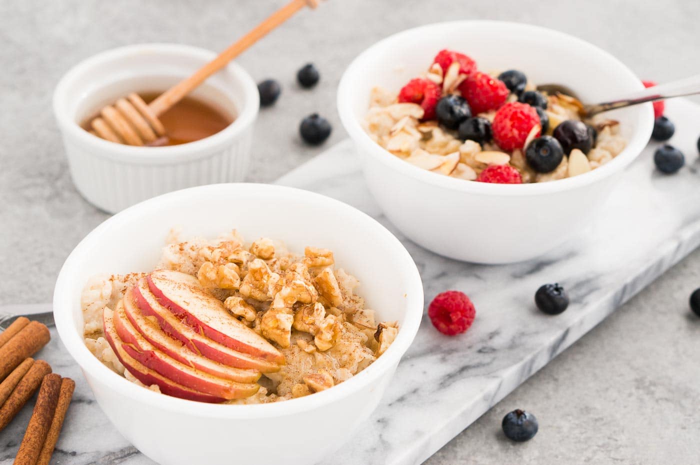 oatmeal with apples and berries in bowls