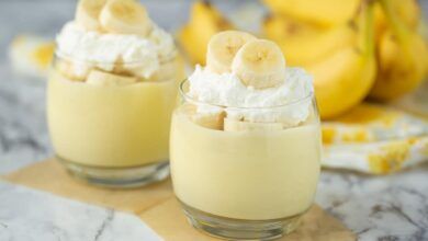 freshly made banana pudding with ripe bananas in the background