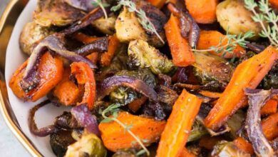 close up image of roasted Brussels spouts and carrots in a bowl