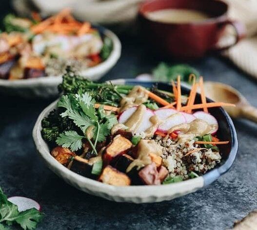 These customizable Quinoa Veggie Bowls with Miso Sesame Dressing will become a weeknight staple. With a quinoa and veggie base topped with a zesty and flavor-packed dressing this easy dinner or lunch recipe is a healthy vegan option for the whole family.