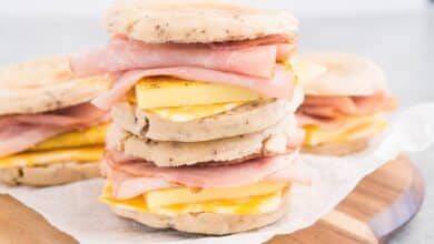 close up image of stacked breakfast sandwiches on a board