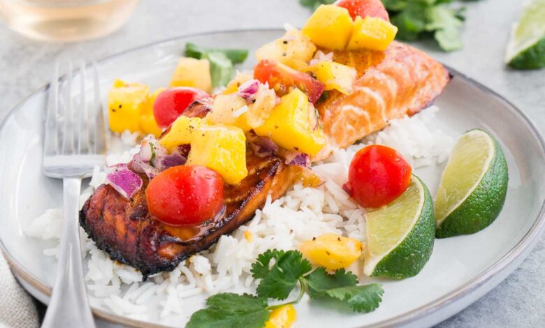 close up image of honey baked salmon with salsa on rice