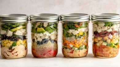 four mason jar salads in a row