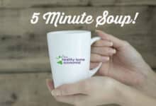 woman holding a white mug of soup made in five minutes