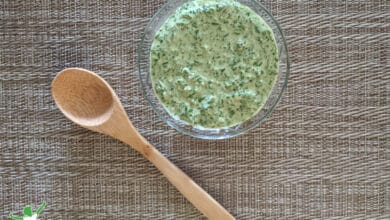 green chimichurri sauce in glass bowl with bamboo spoon