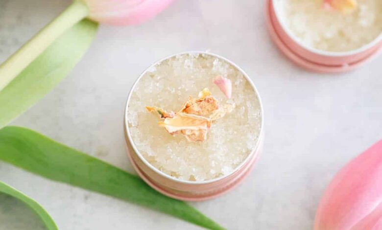 DIY Lip scrub in a small pink metal tin with pink tulips.