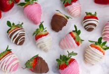 pink, white, and dark chocolate strawberries scattered on the counter
