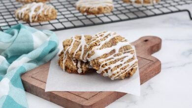 iced oatmeal cookies on a wooden cutting board